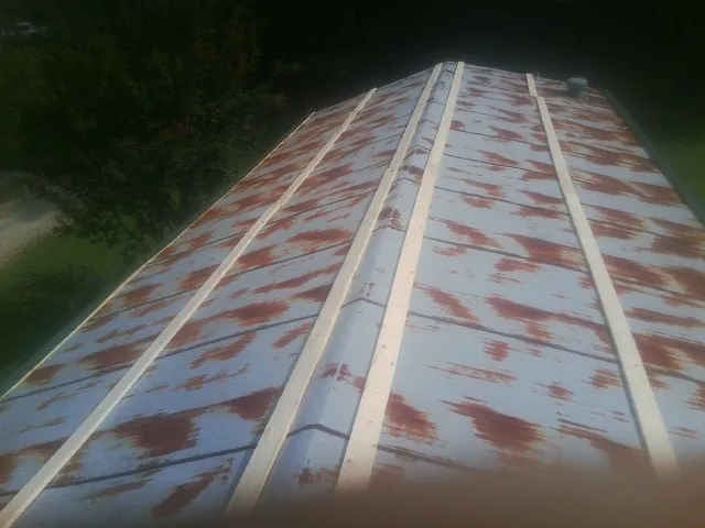 Rusted metal roof panels with new wood purlins before replacement — Storm Damage Roof Repair in Ceres by Roofing Brothers