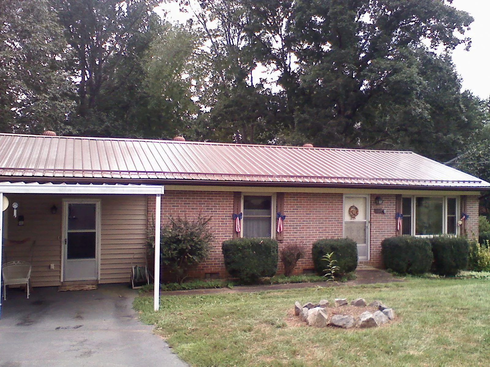 Bronze metal roof and carport on a brick ranch home — Roof Repair work by our crew in Ceres