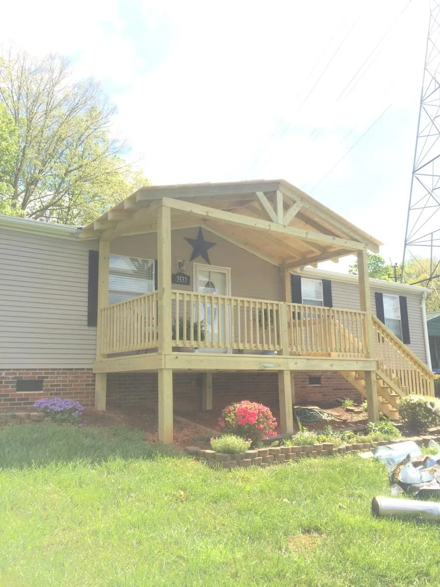 New gabled porch roof and deck railing added to a ranch home in Ceres